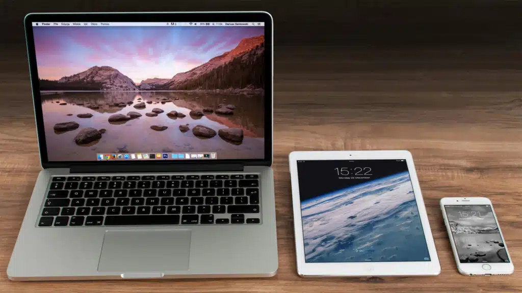 a MacBook, iPad, a iPhone side by side